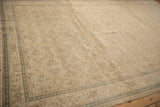 Low-angle view of a distressed Kayseri rug's allover floral design and complex border.