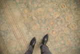 Low pile and even wear of a distressed Kashan carpet in seafoam and coffee brown.
