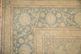 Meandering arabesque vine border of a vintage Kashan carpet in soft sky blue and pale brown.