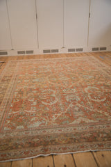 Low perspective across the distressed floral pattern of a vintage Persian Mahal carpet.