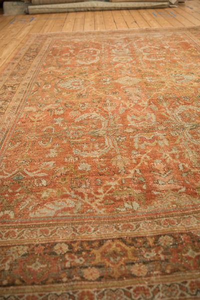 Angled view of a distressed Mahal carpet showcasing its low pile texture and time-softened colors.