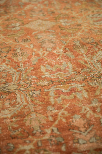 Angled view showing the worn texture and low pile on the distressed Mahal carpet.