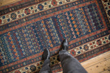 Antique Caucasian rug section, sapphire blue field with geometric flora and a madder root crab border.