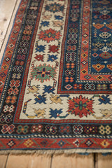 Antique Caucasian runner's crab border with germinating plant motifs on ivory ground.