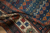 Antique Caucasian rug detail featuring a sapphire blue field, madder root red 