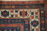 Antique Caucasian rug corner: sapphire blue, madder red floral motifs and crab border.