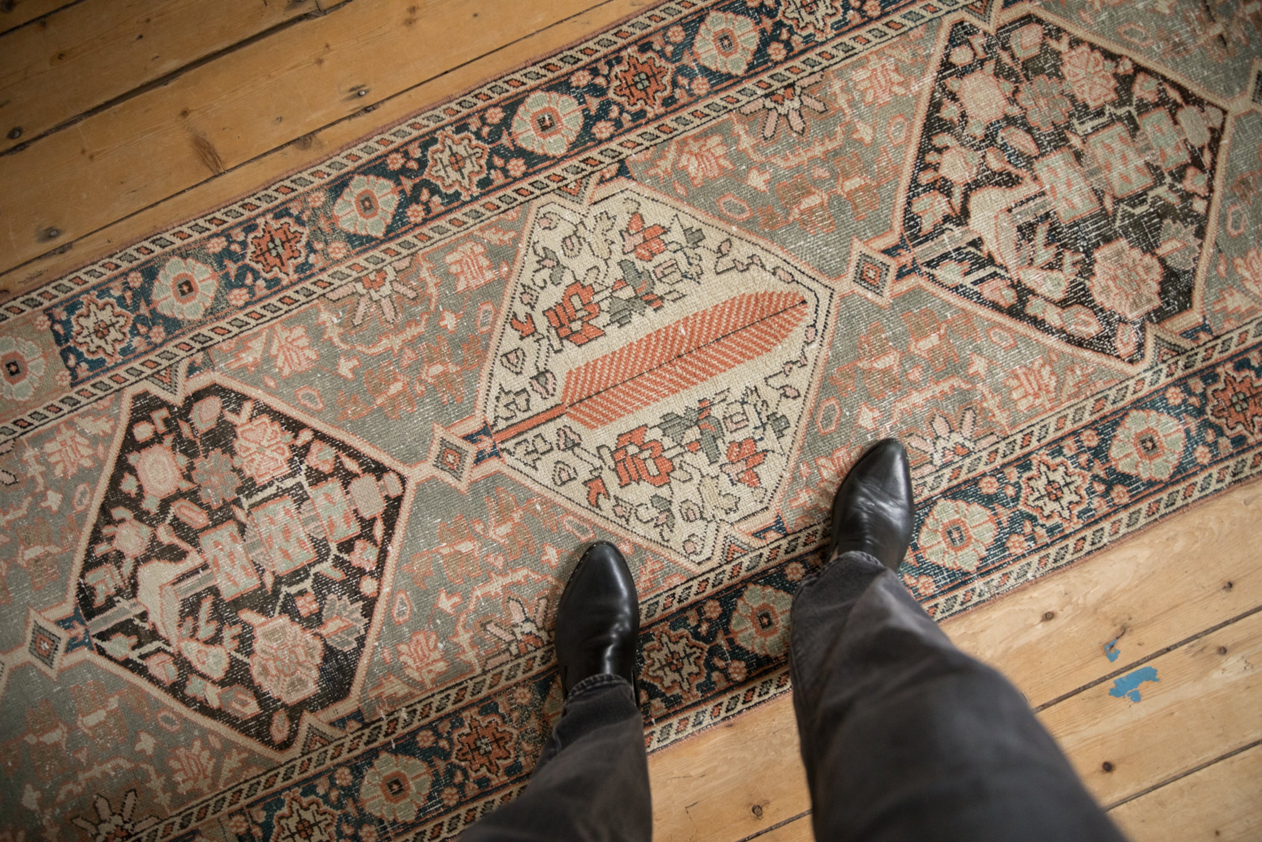 Distressed Bakhtiari runner, repeating cypress trees and medallions, with time-softened tangerine and charcoal.