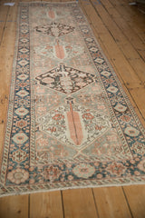 Distressed vintage Bakhtiari runner's cobalt border and worn tangerine floral motifs.