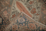 Hand-knotted Bakhtiari runner shows distressed tangerine, teal pile, foundation, and selvage.