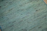 Plush woolen pile with abrashed striations of powder blue and silver shades.
