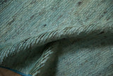 Soft, plush abrashed pile in powder blue and silver striations, with visible side selvage.