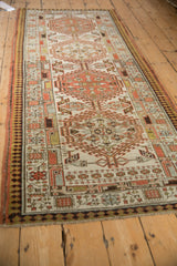 Vintage distressed Serab runner displaying geometric bouquets, pawn border, and worn texture.