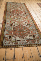 Distressed Serab runner corner with madder red geometric patterns and detailed pawn border.