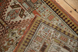 Distressed vintage Serab rug runner's geometric borders and unique pawn motif.