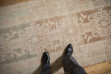 Distressed vintage Hamadan runner: abrashed ground, geometric borders, and primitive blossom motifs.