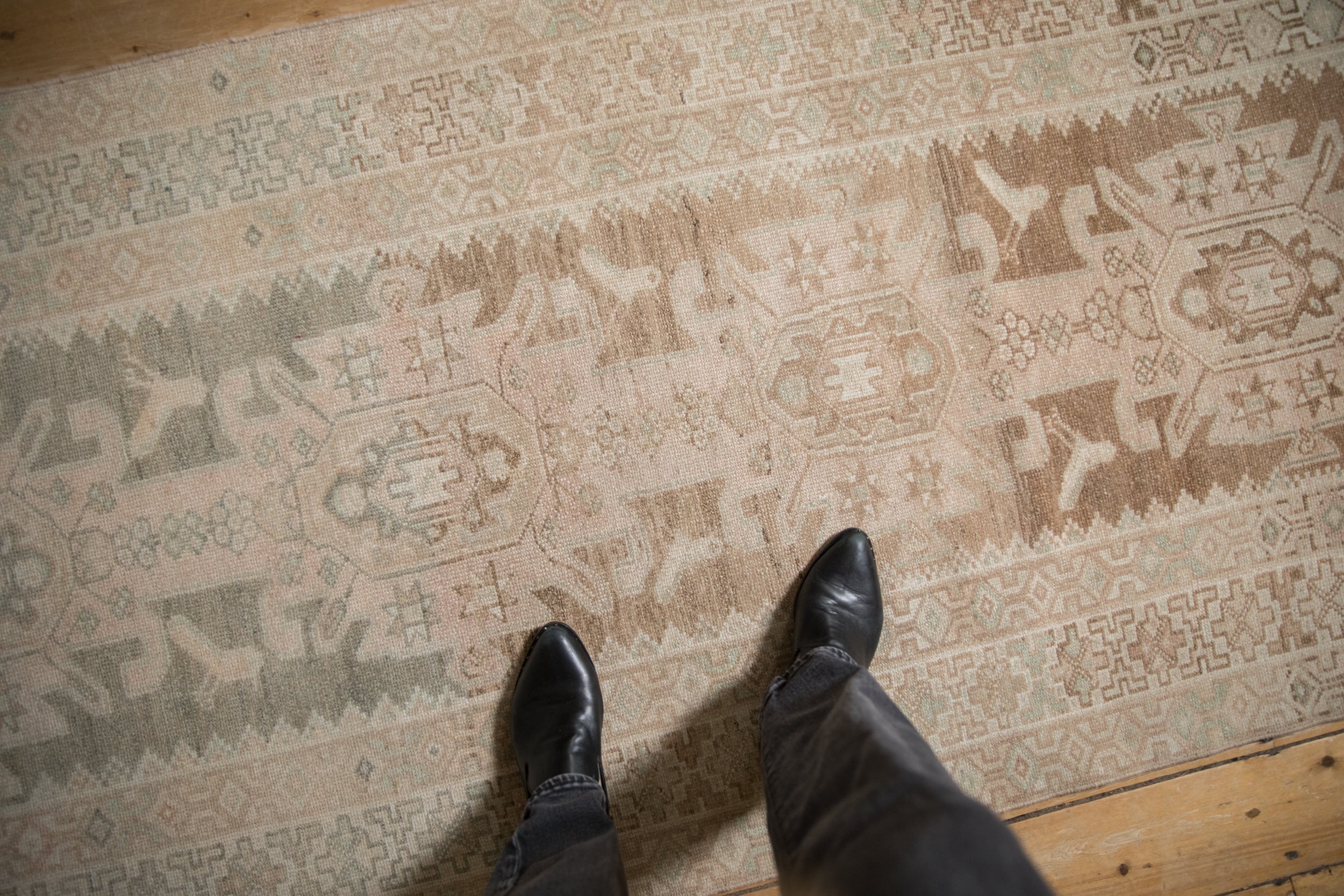 Distressed vintage Hamadan runner: abrashed ground, geometric borders, and primitive blossom motifs.