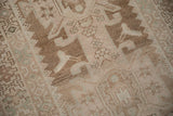 Distressed vintage Hamadan runner's even wear revealing geometric birds and primitive blossoms in neutral tones.