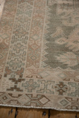 Muted geometric patterns and distressed texture on a vintage Hamadan rug runner.