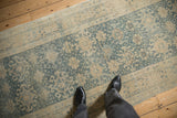 Distressed Vintage Bijar runner with pale blue and ivory floral guls, displaying low pile wear.
