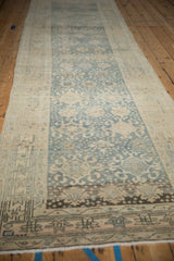 Distressed Bijar runner featuring faded blue field, ivory motifs, and dark geometric border.