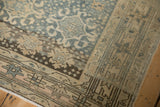 Distressed Bijar runner border, showing faded blue, beige colors and faint foundation.