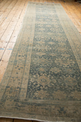 Long distressed Bijar runner, mostly even wear on faded blue and beige floral field.