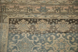 Distressed Bijar runner's worn pile, faded barber-pole border, and visible knot heads.