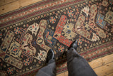 Antique Caucasian Soumac runner displaying geometric palmettes and arabesques in brown, red, blue, beige.