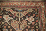 Antique Caucasian Soumac runner corner, displaying intricate borders with red, blue, and beige motifs.