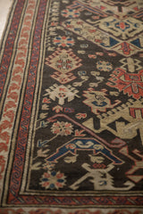 Hand woven Caucasian Soumac rug detail showing chocolate, beige, red, and blue motifs.