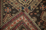 Antique Soumac runner's chocolate brown field with geometric patterns and textured reverse.