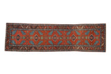 Antique Northwest Persian runner, blue finned leaves and florals on rich red, circa 1910s.