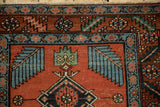 Northwest Persian rug detail with red field, blue finned leaf, and lightning serrated vine border.