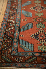Antique Northwest Persian runner detail of red field, blue finned leaves, and lightning border.
