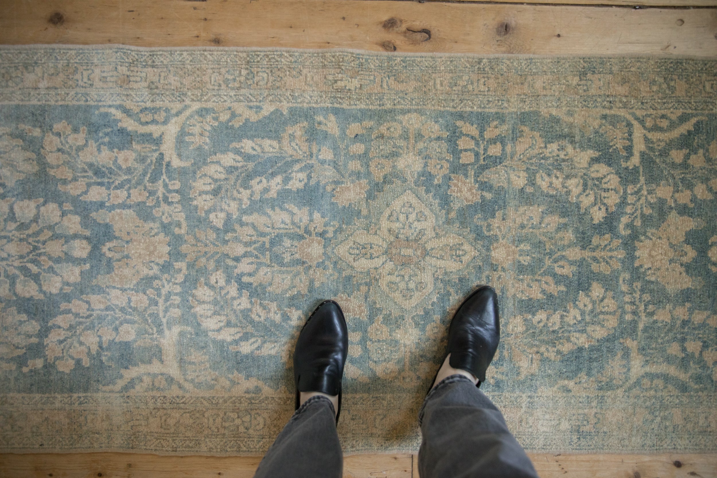 Distressed vintage Persian Lilihan runner with faded powder blue floral pattern.