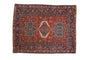Hand-knotted vintage Karaja rug, brick red field, navy medallion, geometric florals, Herati border.
