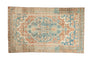 Distressed Persian Bakhtiari rug, bold medallion, floral patterns, in sky blue, coral, and beige.