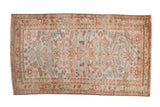 Distressed Persian Mehreban rug with double medallion, geometric field, muted pink, sand, and blue.
