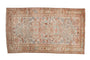 Distressed Persian Mehreban rug with double medallion, geometric field, muted pink, sand, and blue.