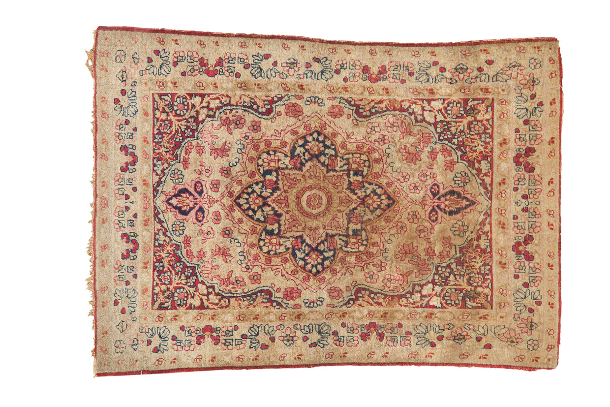 Antique Kerman square rug, concentric floral medallion, book cover spandrels, ivory, navy, red.