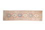 Distressed Turkish Dosemealti runner, stepped medallions in dusty blush, sapphire, and ivory.