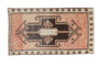 Distressed Turkish Kars rug, geometric shield medallion on abrashed pale peach ground.