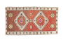 Distressed Kars rug mat: abrashed chestnut ground with stepped medallions and bright floral guls.