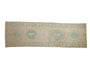 Distressed vintage Karaja runner rug, pale blue geometric medallions on ivory field.