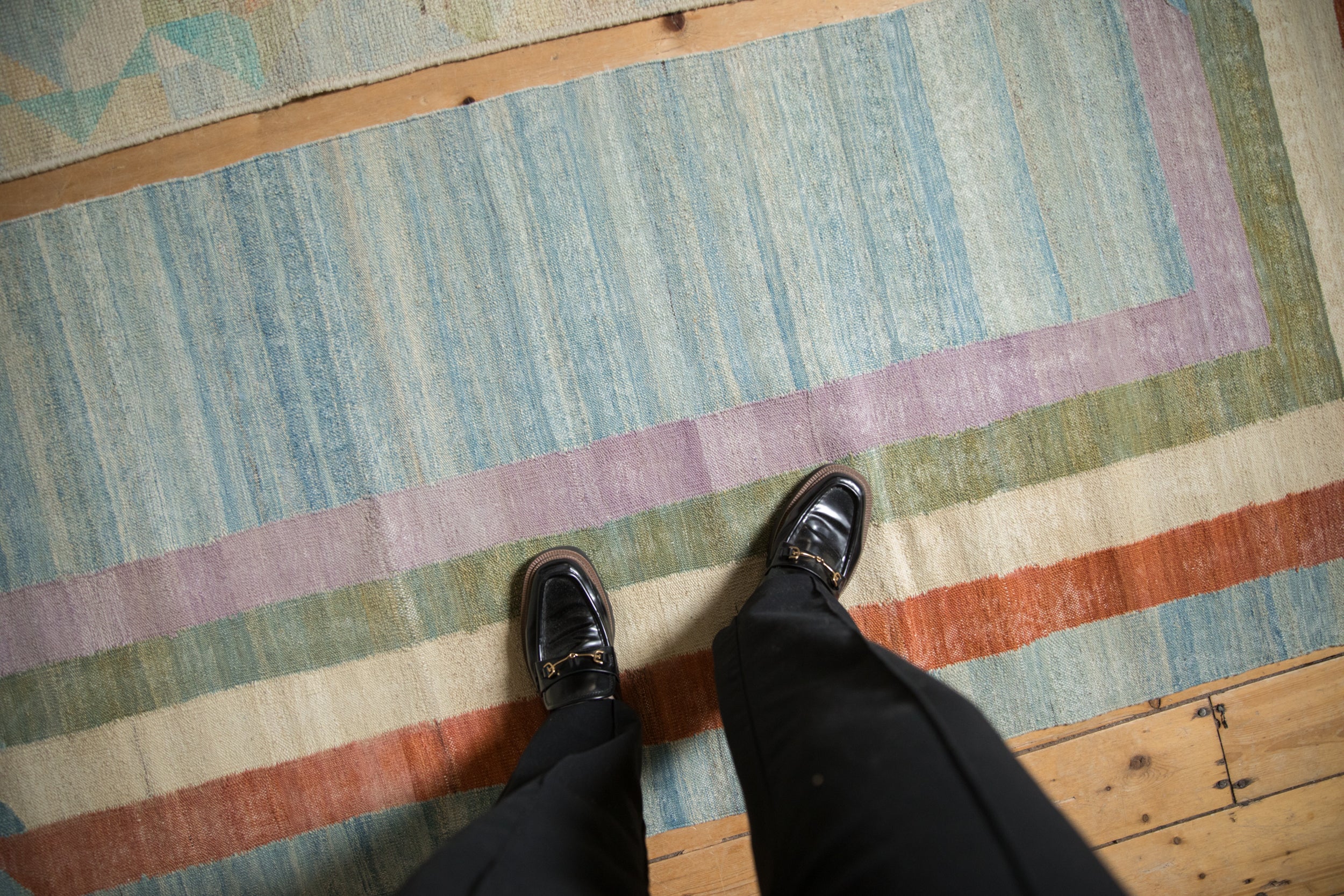 Abstract striped kilim runner with abrashes in powder blue, pale lavender, and terra cotta.