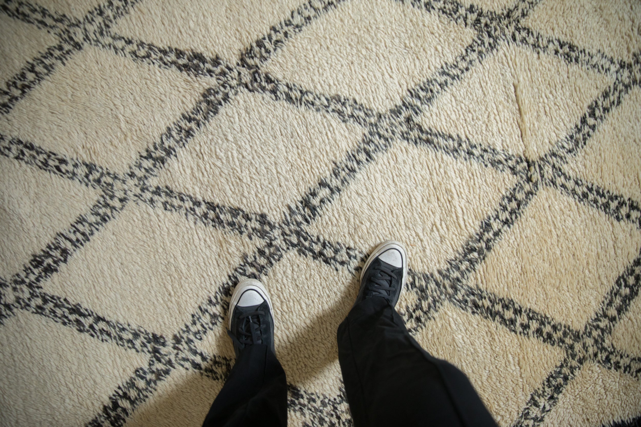 Long plush ivory pile of the vintage Moroccan rug with oxidized silver trellis.