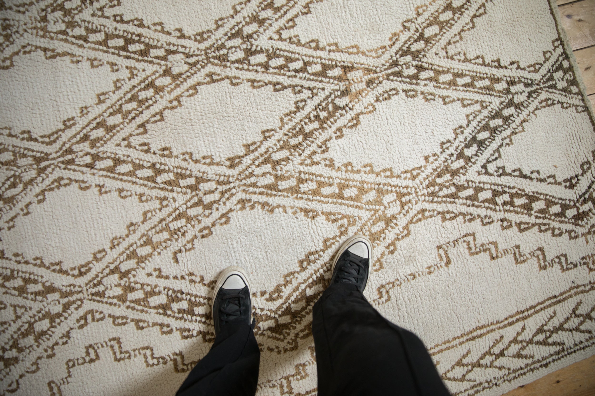 Ivory wool pile and dusty bronze geometric diamond pattern on a vintage Moroccan carpet.