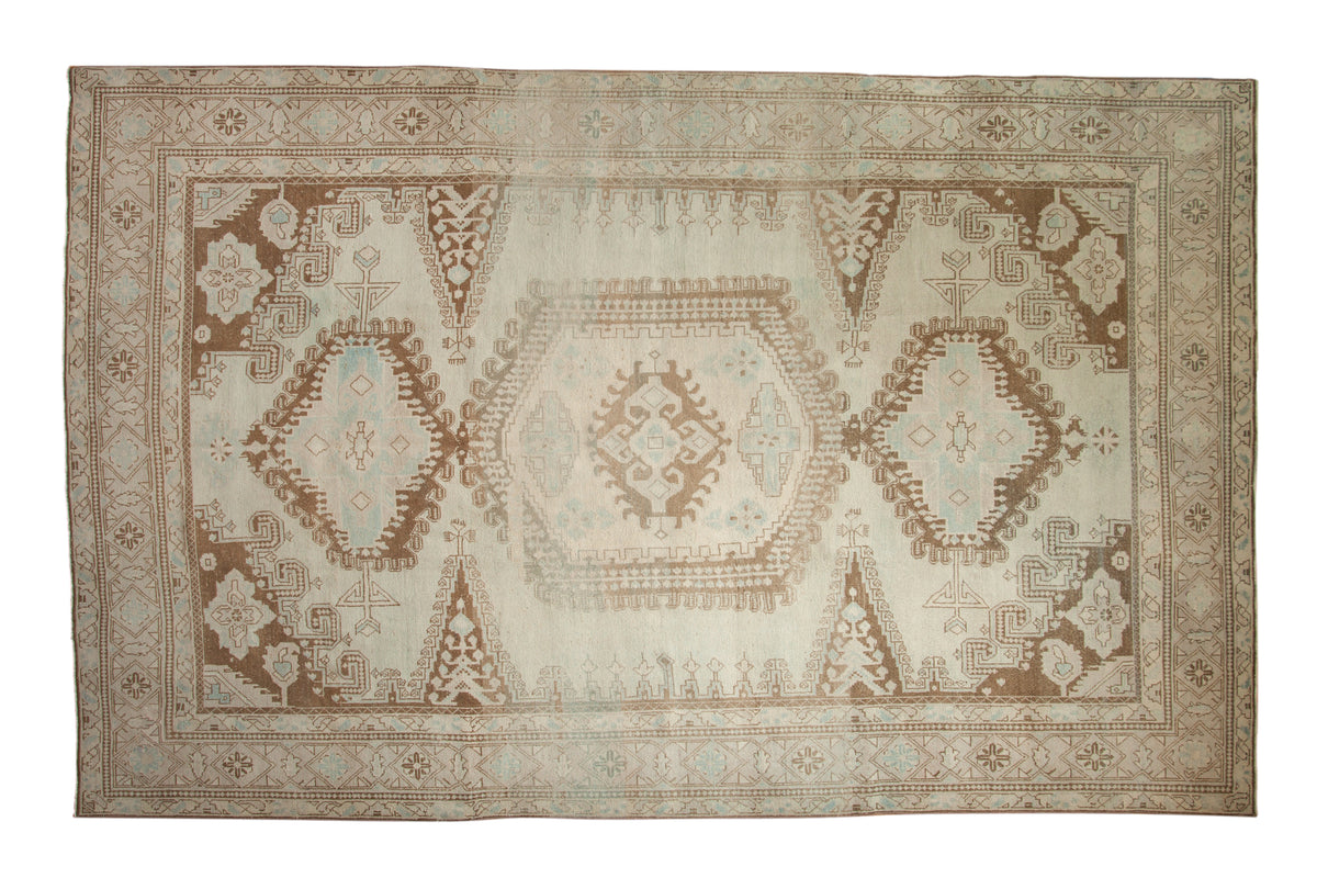 Distressed Vintage Persian Veece rug, elongated central medallion, ivory, pale brown, powder blue.