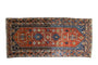Antique Persian Mehraban runner, madder red and navy field featuring geometric floral motifs.