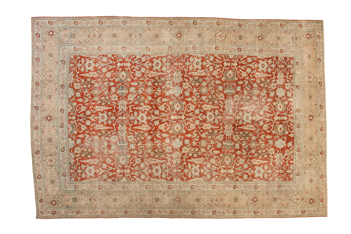 Distressed vintage Tabriz carpet, cherry red allover field with elaborate ivory palmettes.